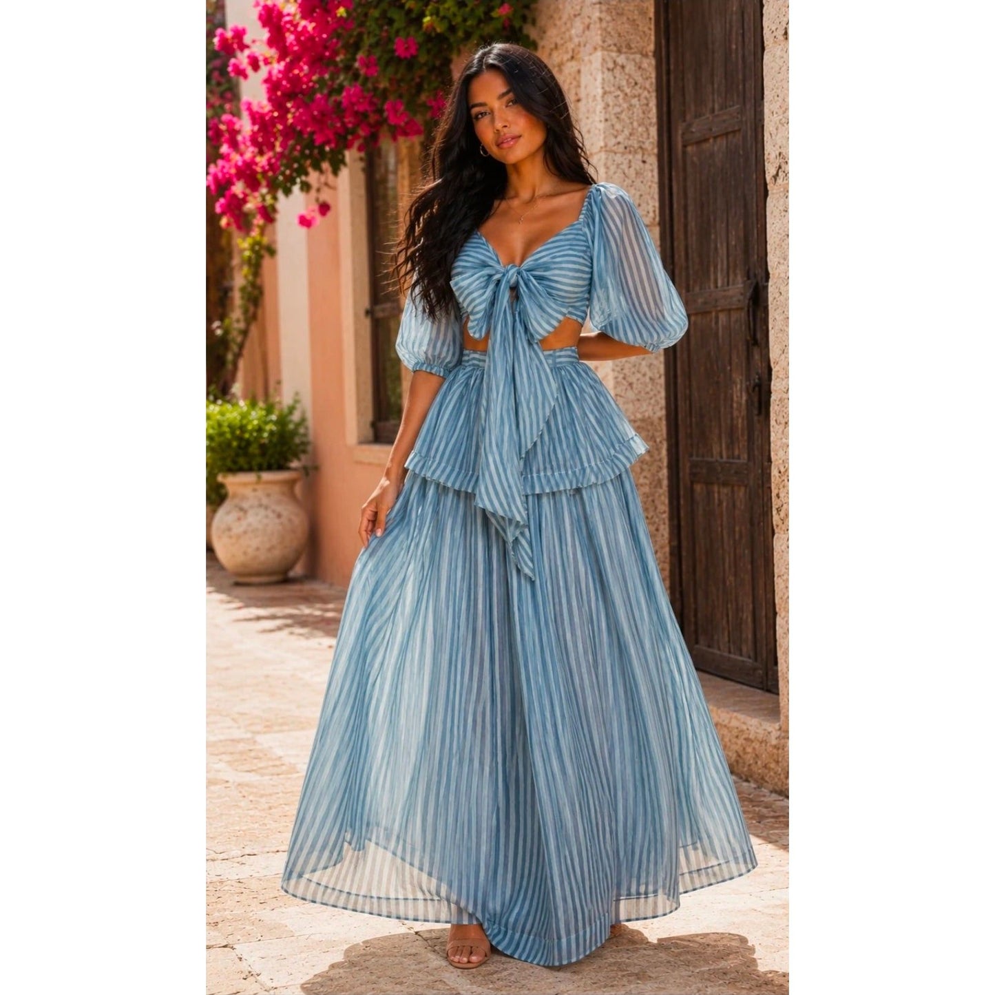 Myrtice Collection blue and white striped two-piece maxi skirt and tie-front crop top set with puff sleeves.
